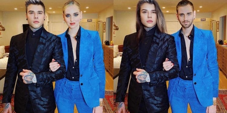 Immagine elaborata con FaceApp. Due coppie di individui posano per una foto in un ambiente moderno. Ogni coppia include una persona in abito blu con una camicia nera e un'altra in abito nero. Entrambe le coppie stanno a braccetto, con espressioni sicure. Sul pavimento è visibile un tappeto.