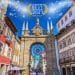 Una vivace strada a Braga, in Portogallo, è caratterizzata da edifici tradizionali colorati e un grande arco decorativo con dettagli decorati sotto un cielo azzurro brillante. Il testo "Migliore destinazione europea 2021, Braga" è visualizzato con scintillii sopra l'arco.