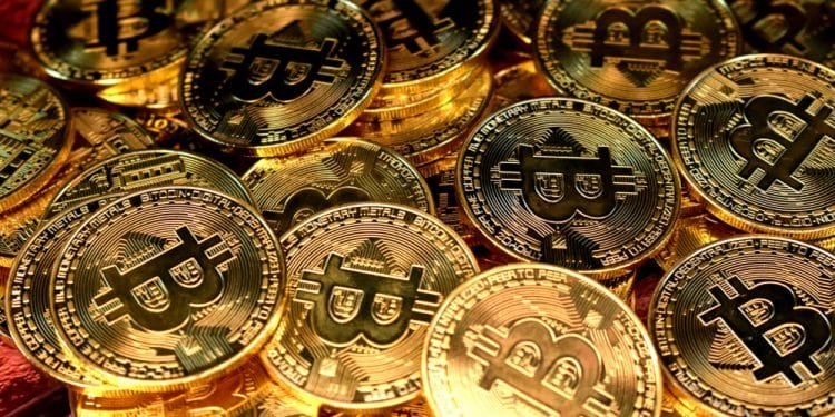 Una pila di monete color oro con il logo Bitcoin ben visibile su ciascuna di esse, con la lettera "B" attraversata da due linee verticali. Questi Bitcoin Madeira sono estremamente dettagliati e appaiono lucidi, catturando magnificamente la luce.