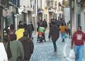 A Martim Moniz di Lisbona in Portogallo, dove vivono molti immigrati, si sta generando xenofobia. I questa strada stretta acciitolata alcuni indossano giacche e portano borse della spesa. Un fattorino di cibo a domicilio su uno scooter si prepara a farsi strada tra la gente.