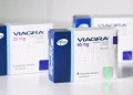 Sono mostrate tre scatole di Viagra Pfizer, l'attenzione è rivolta a quella da 50 mg con la confezione blu e bianca, in vendita senza ricetta medica in Portogallo. Le altre scatole sono etichettate con 25 mg, 50 mg e un'altra sullo sfondo.