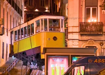 Una vettura della Funicolare di Lisbona deragliata che viene rimossa durante la notte sollevandola da terra, per consentire indagini più specifiche.