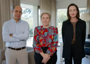 Miguel Mota Freitas, il nuovo CEO di Worten Claudia Azevedo, al centro e Minette Bellingan posano in piedi in un salotto con delle finestre sullo sfondo.